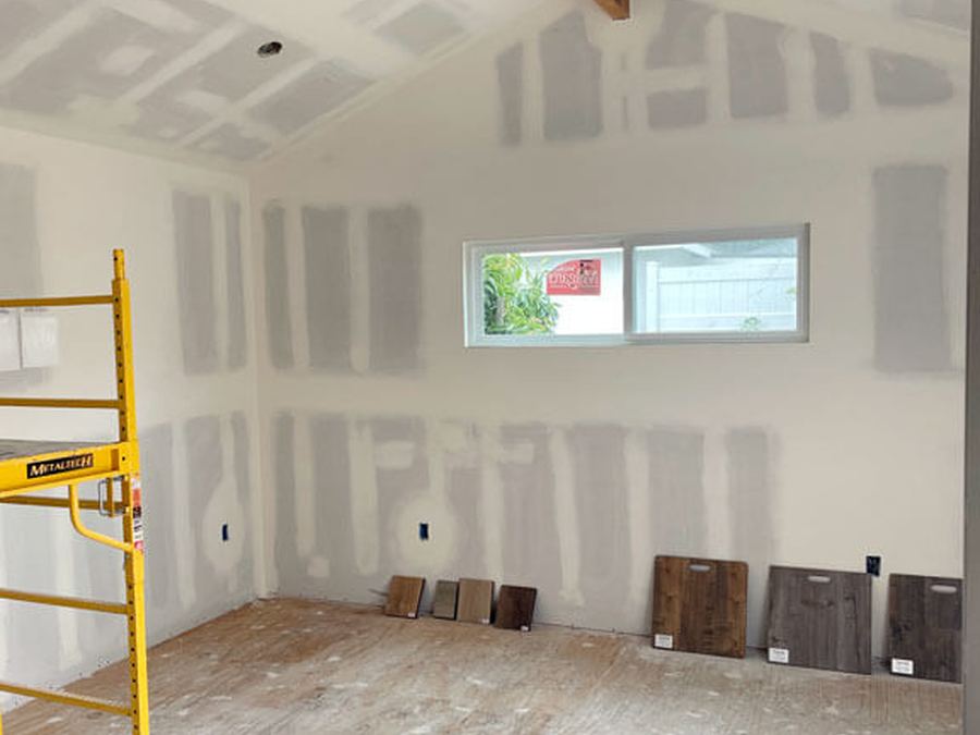 Interior room with newly hung and taped drywall ready for finishing